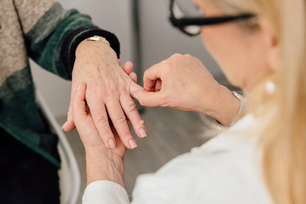 Doctor examining a patient’s hand